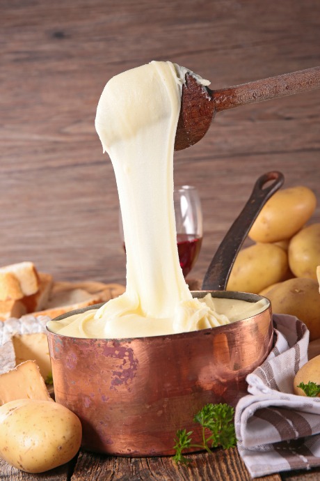 Aligot is a French dish that includes riced potatoes and Tomme or Cantal cheese, along with garlic, butter, and cream.