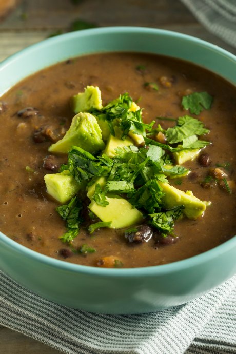 Black bean soup is hearty and filling, and it goes well with avocado and cilantro