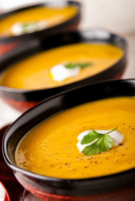 Butternut squash is an ideal soup ingredient. Top with sour cream and fresh cilantro.