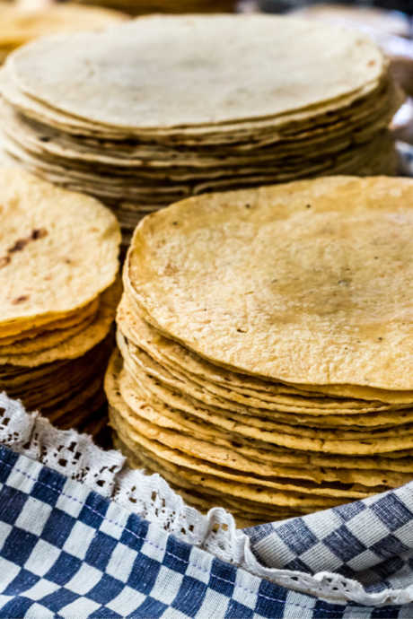 Homemade Enchiladas: Buy the freshest corn tortillas you can find. Look for condensation on the inside of the bag. Fresh tortillas are also soft and flexible. Don’t buy a bag of stiff, dry tortillas.