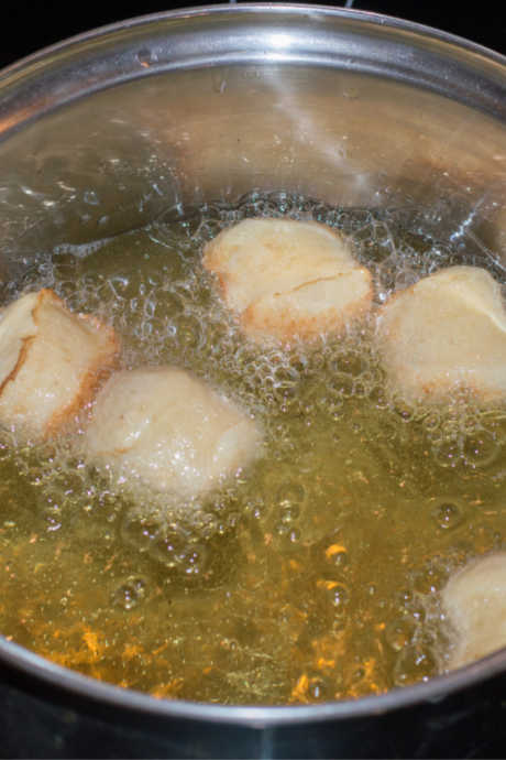 Heat two inches of oil in a Dutch oven for frying. Cook pączki a few at a time on both sides, turning when they are golden brown. Allow them to cool on a wire rack.