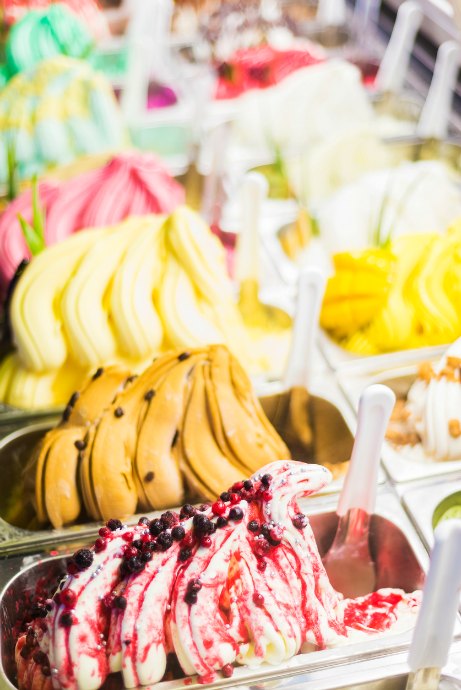 Gelato is made with a greater proportion of milk than cream, so the fat content is lower than ice cream. However, gelato contains less air than ice cream because it is churned more slowly.
