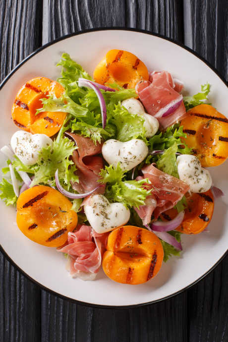 Grill apricots and use them to top fresh green salads with ingredients like red onion, prosciutto, and burrata.