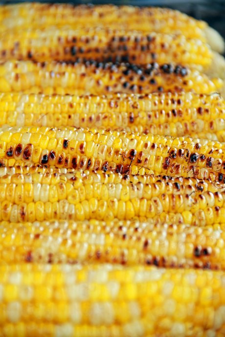 Grilling uncovered corn will char the kernels, but the corn isn't as juicy as when grilled in the husk or in foil. If you're determined to get those grill marks, we suggest cooking it while covered. Then put it on the grill uncovered for a minute or two before serving.