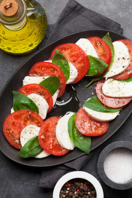 Classic insalata caprese contains only a handful of ingredients, like tomatoes, mozzarella, basil, olive oil, and salt and pepper.