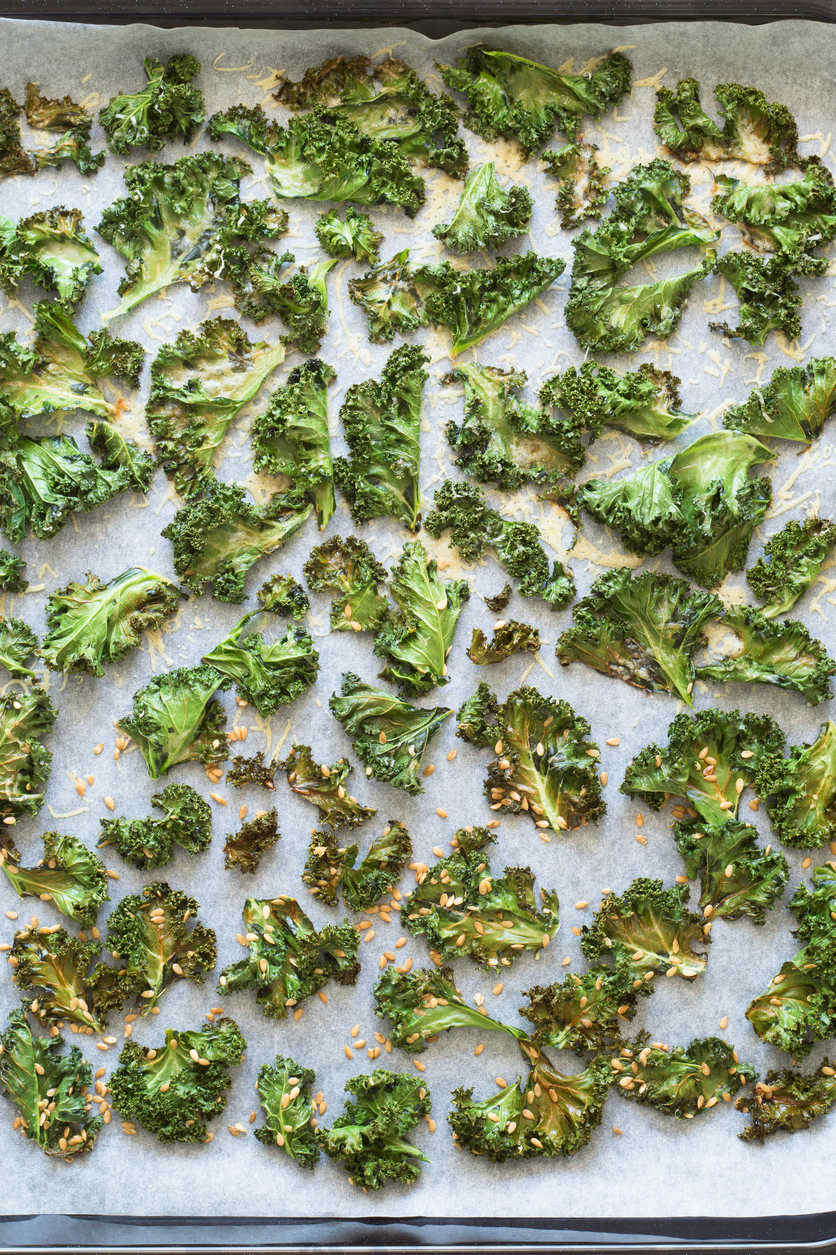 Kale chips are surprisingly tasty: rub leaves with olive oil, sprinkle them with seasoning, and bake at 350°F until the edges brown.