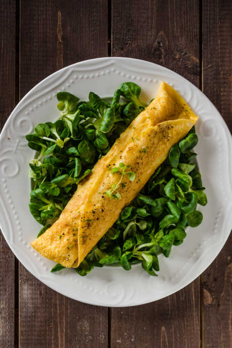 A French omelet features chunky toppings spread over it. But first, some seasonings and fillings do belong inside. Mix salt and pepper into your raw eggs before adding them to the pan.