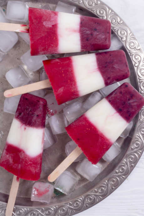 Yogurt Popsicles: Make three batches of yogurt mixtures for the red, white, and blue layers in these pops.