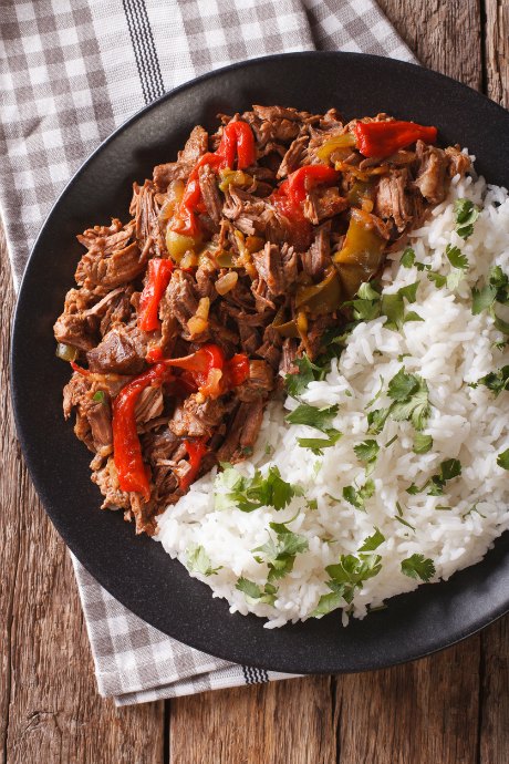 Ropa viejo is one of Cuba's signature dishes. Sear chuck roast on the stovetop, then slow cook it with tomato sauce, bell pepper, onion, green chiles, herbs and spices.