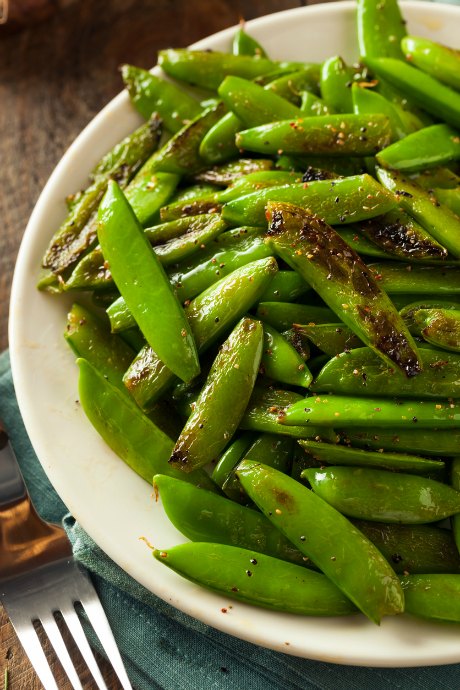 The key to cooking sugar snap peas is to keep it quick. Toss them with olive oil, salt and pepper.