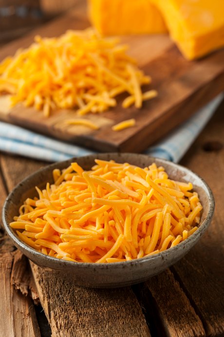 Instead of buying bagged pre-shredded cheese (which contains cellulose to keep it from sticking together), use a food processor to quickly grate any cheese.