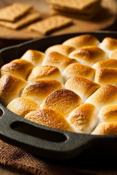 Fill your skillet with chocolate chips, top it with marshmallows, and pop it in the oven or set it over the fire. Then use the graham crackers to scoop up the melted chocolate and marshmallows.