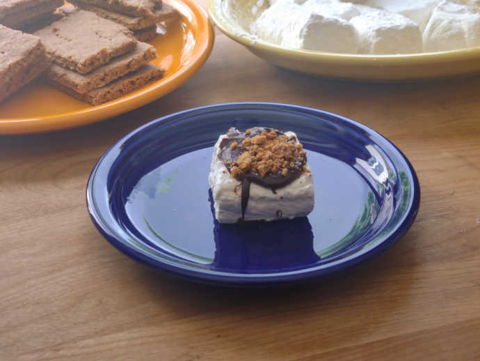 Homemade S'mores: Another easy-to-eat way to dish up s’mores is by drizzling melted chocolate over marshmallows, then sprinkling crushed graham crackers over top. Chill on a parchment paper-covered baking sheet and serve.